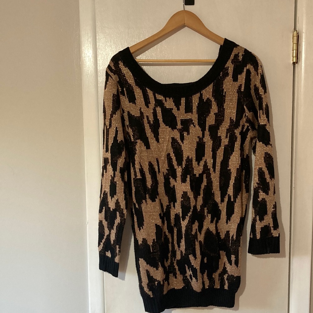 Woman’s black/gold glittered long sweater with scooped and open back.